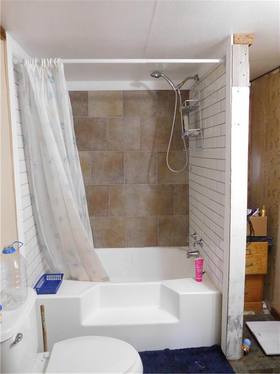 142 Ellis Road Southeast Rome, GA 30161 - Photo 12 of 19 a bathroom with a white bath tub a toilet and a shower curtain