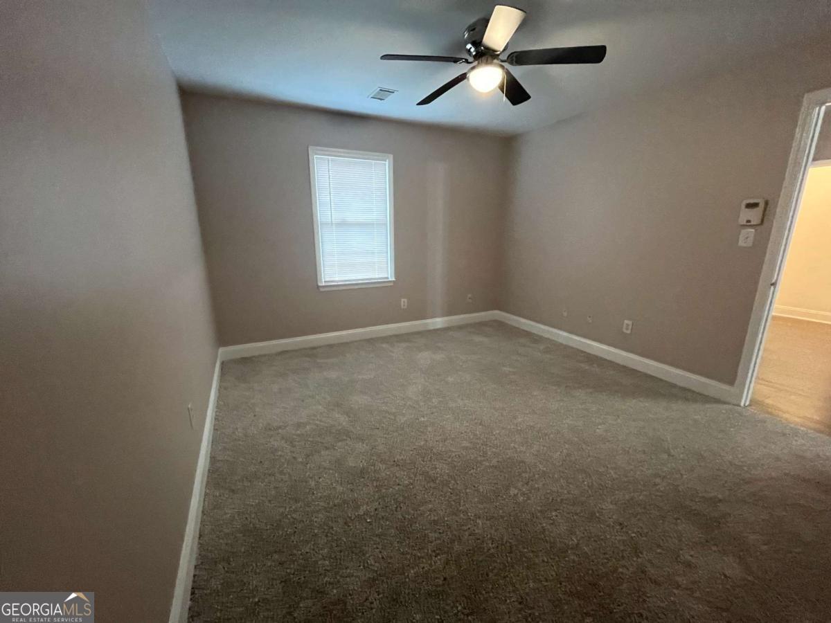565 Rustwood Drive Athens, GA 30606 - Photo 11 of 16 an empty room with windows and fan