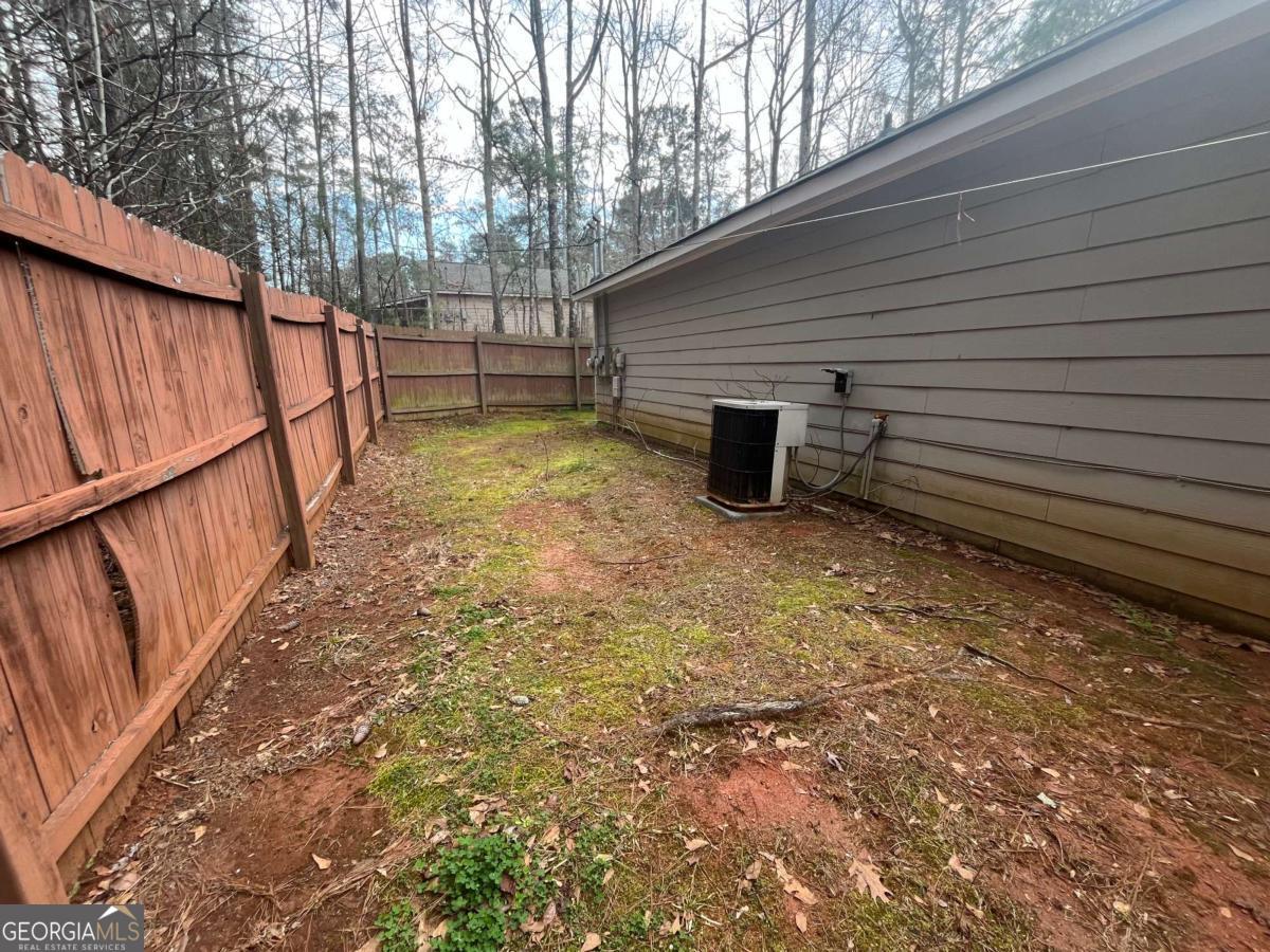 565 Rustwood Drive Athens, GA 30606 - Photo 16 of 16 a view of a backyard with stairs and wooden fence