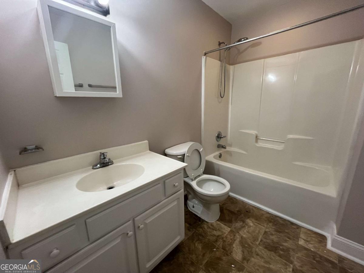 565 Rustwood Drive Athens, GA 30606 - Photo 7 of 16 a bathroom with a sink toilet and shower