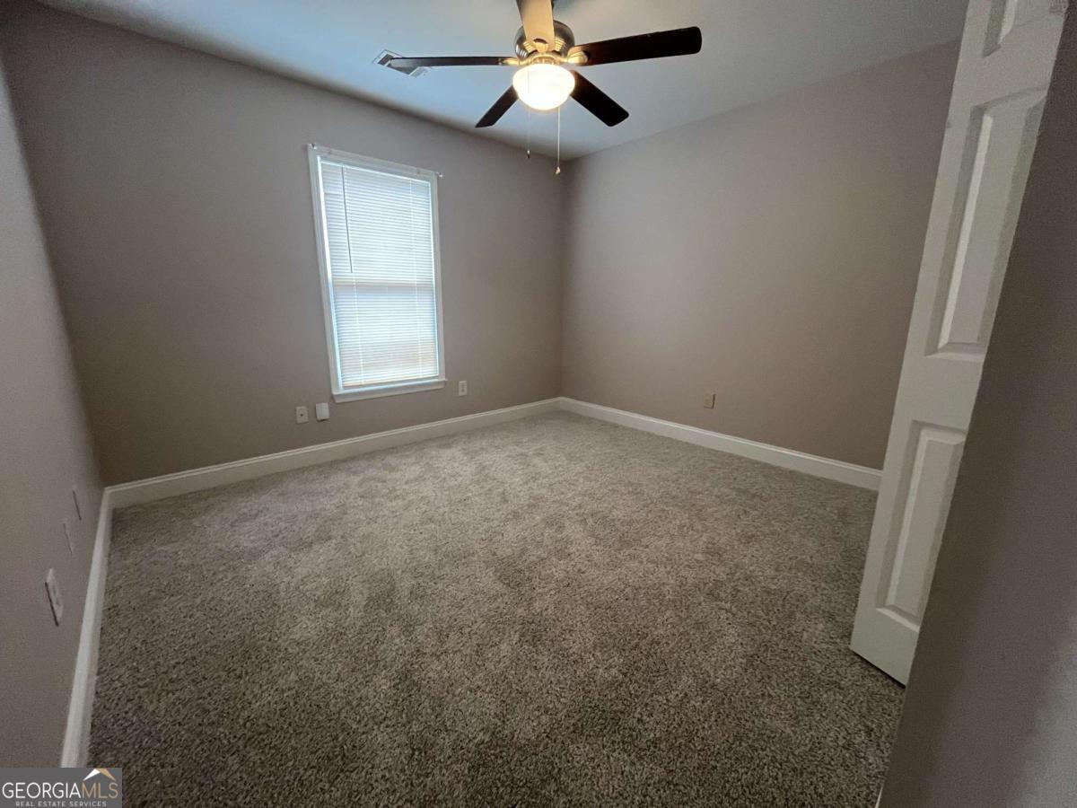 565 Rustwood Drive Athens, GA 30606 - Photo 9 of 16 an empty room with windows and fan