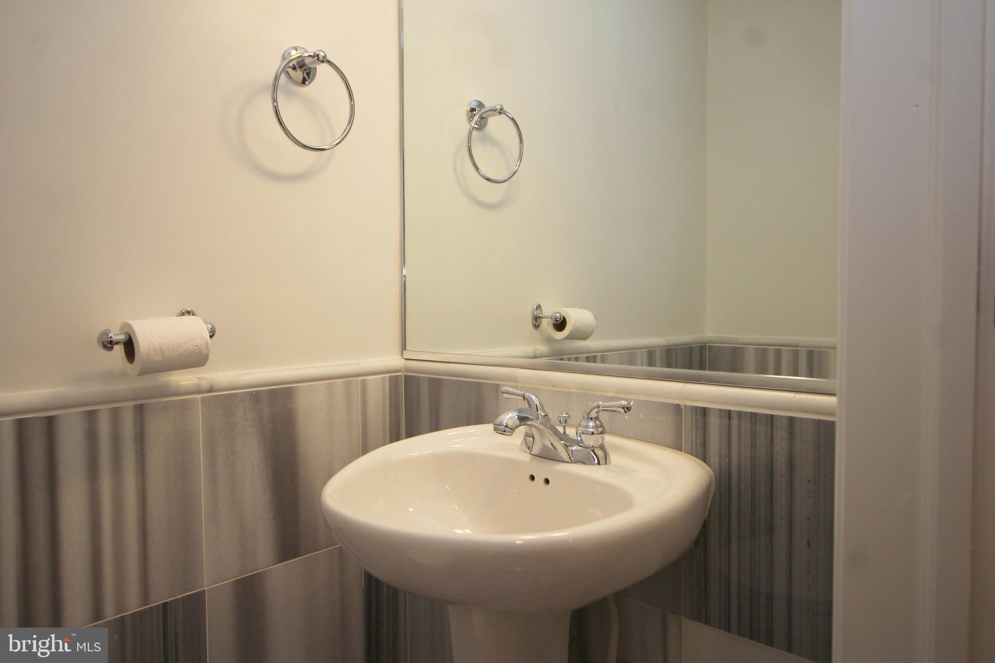 1354 Euclid Street Northwest, Unit 303B Washington, DC 20009 - Photo 11 of 16 a bathroom with a sink and mirror