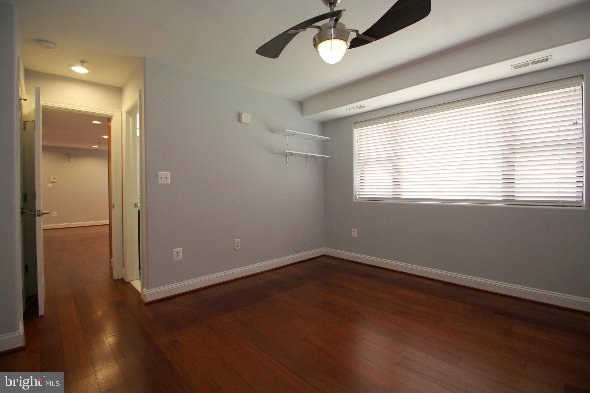 1354 Euclid Street Northwest, Unit 303B Washington, DC 20009 - Photo 12 of 16 an empty room with wooden floor and windows