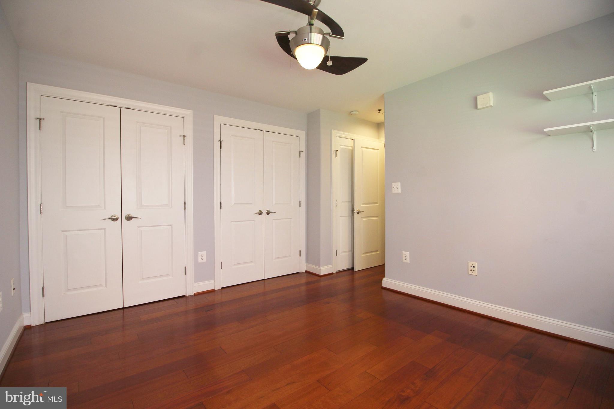 1354 Euclid Street Northwest, Unit 303B Washington, DC 20009 - Photo 13 of 16 a view of an empty room with a ceiling fan and window