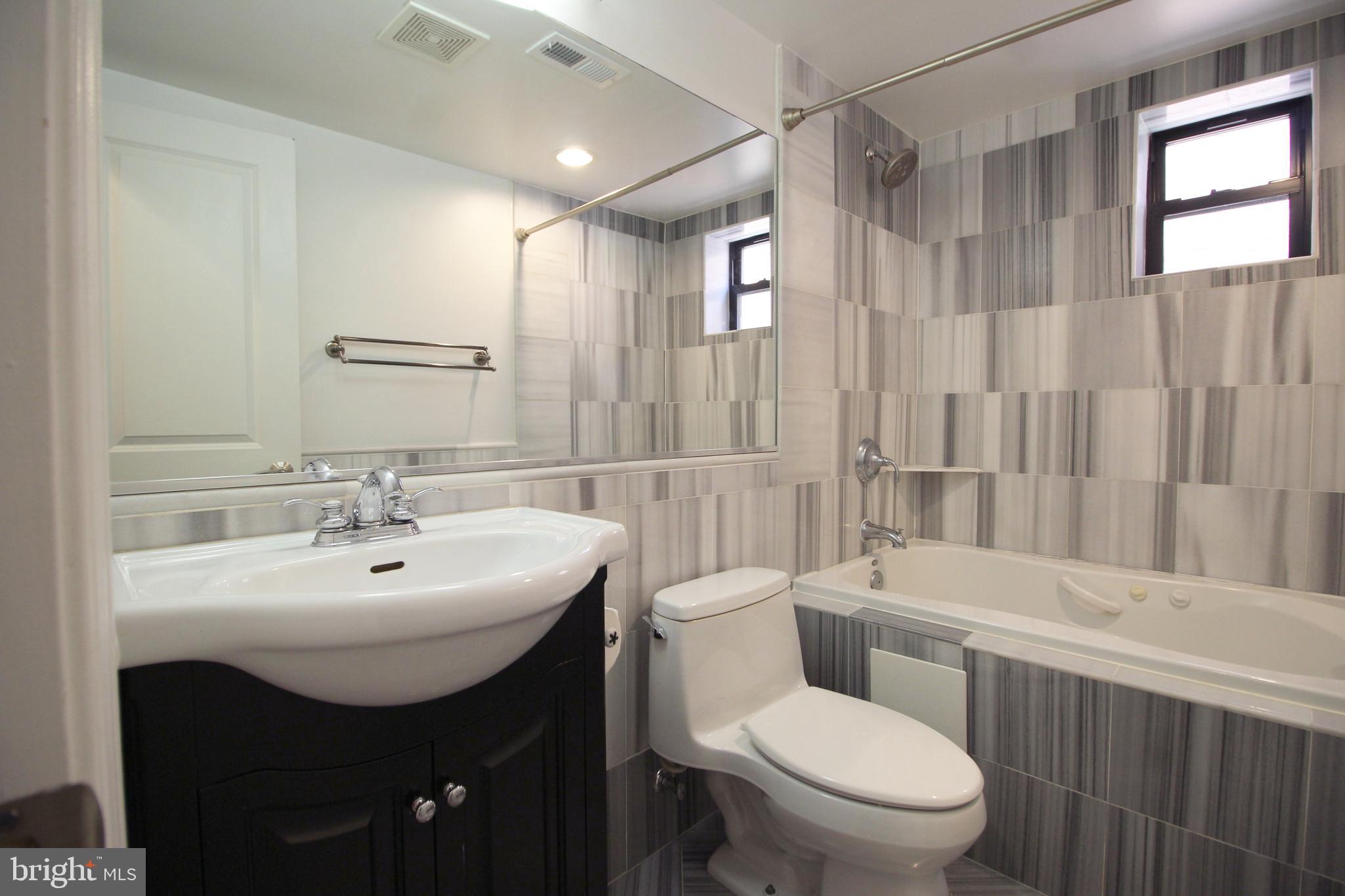 1354 Euclid Street Northwest, Unit 303B Washington, DC 20009 - Photo 14 of 16 a bathroom with a sink toilet and shower