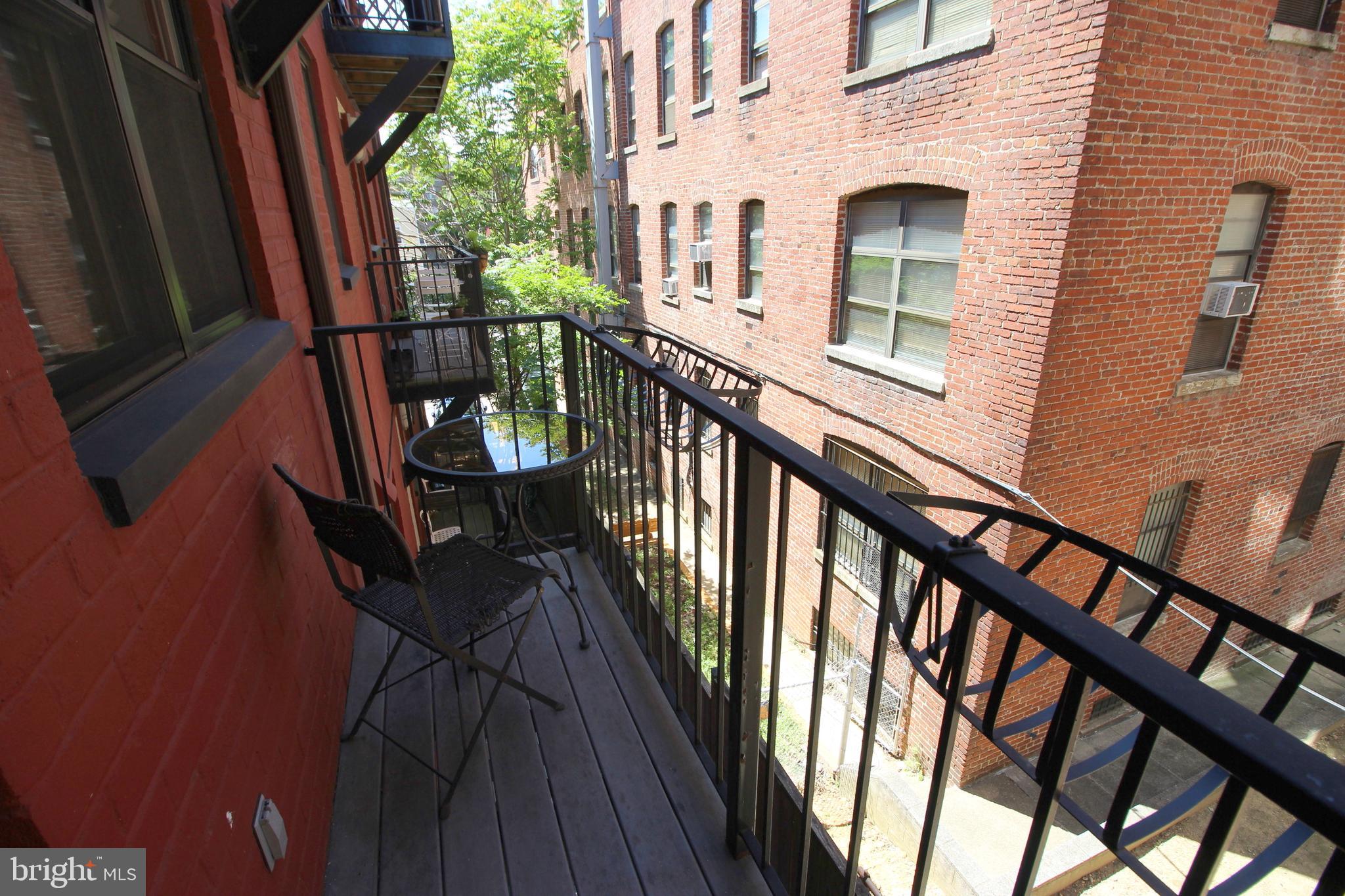 1354 Euclid Street Northwest, Unit 303B Washington, DC 20009 - Photo 3 of 16 a view of balcony with wooden floor and staircase