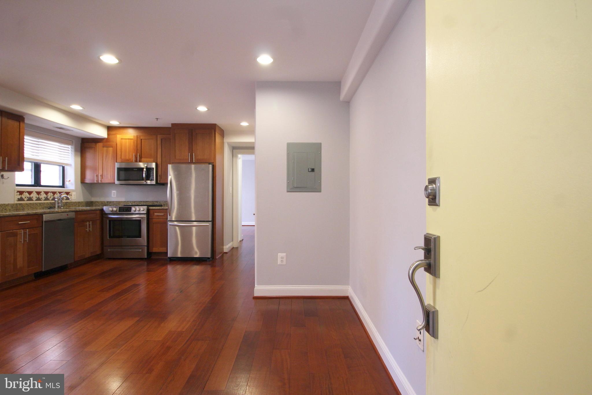 1354 Euclid Street Northwest, Unit 303B Washington, DC 20009 - Photo 4 of 16 a kitchen with stainless steel appliances a refrigerator and a stove top oven