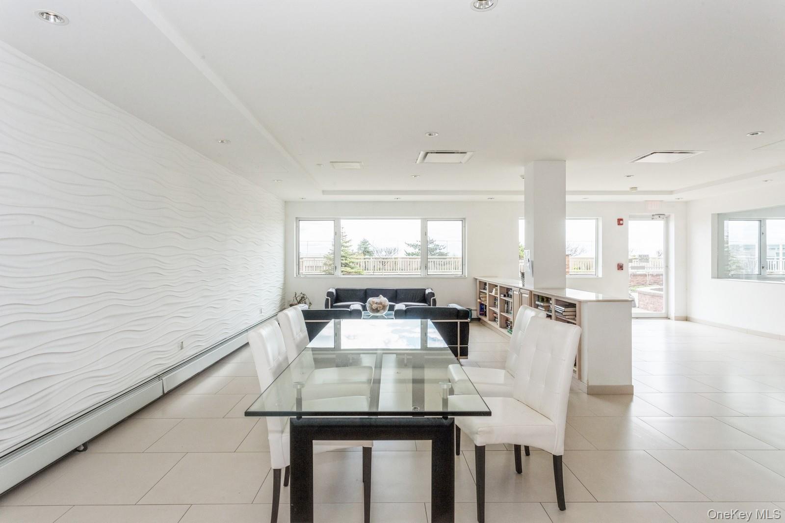 830 Shore, Unit 2O Long Beach, NY 11561 - Photo 13 of 19 a view of a dining room with furniture and wooden floor