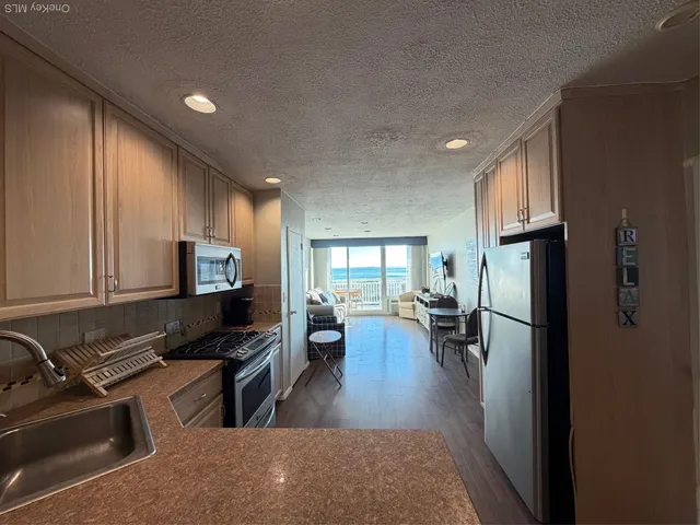 a kitchen with a refrigerator and a sink