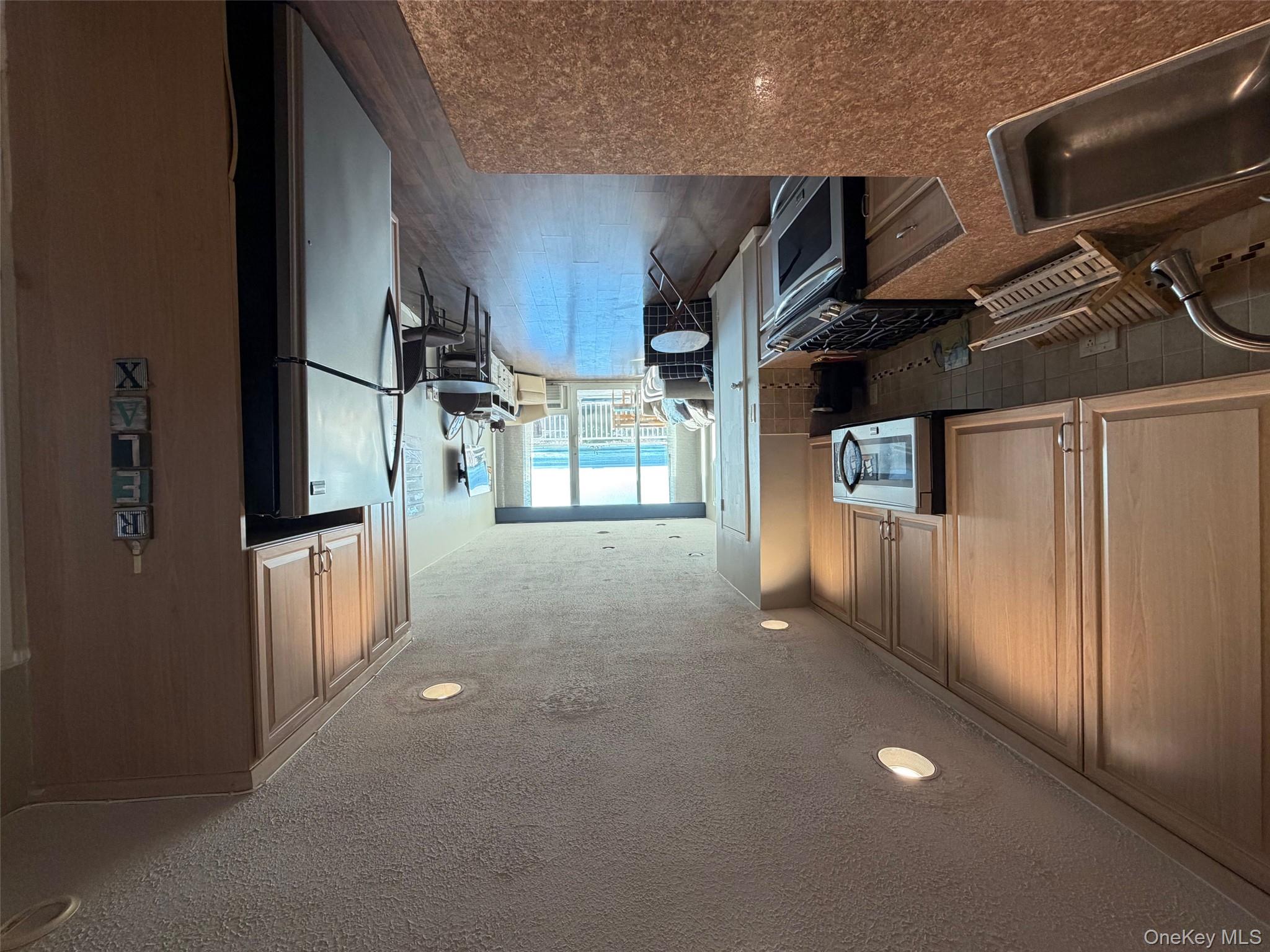830 Shore, Unit 2O Long Beach, NY 11561 - Photo 3 of 19 a kitchen with a refrigerator and a sink