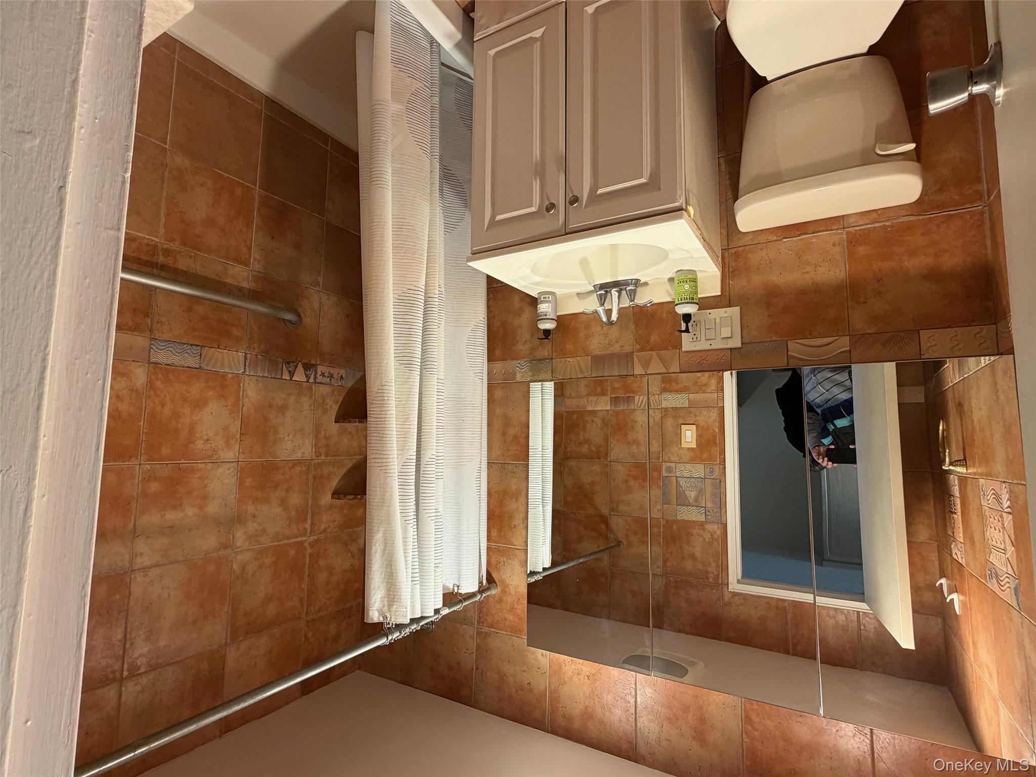 830 Shore, Unit 2O Long Beach, NY 11561 - Photo 6 of 19 a bathroom with a sink toilet and shower