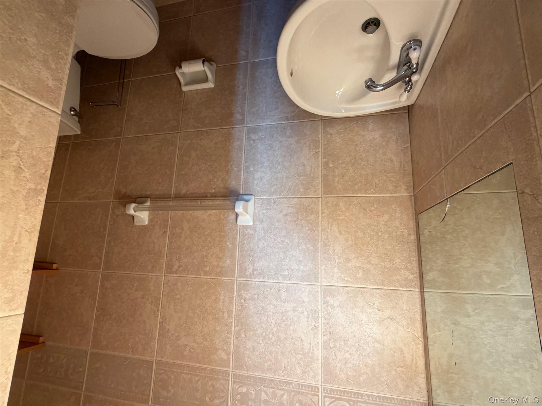 830 Shore, Unit 2O Long Beach, NY 11561 - Photo 9 of 19 a bathroom with a sink and a toilet