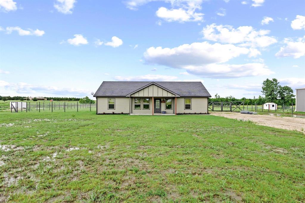 293 Private Road Honey Grove, TX 75446 - Photo 2 of 29 a view of a house with a big yard plants and large trees