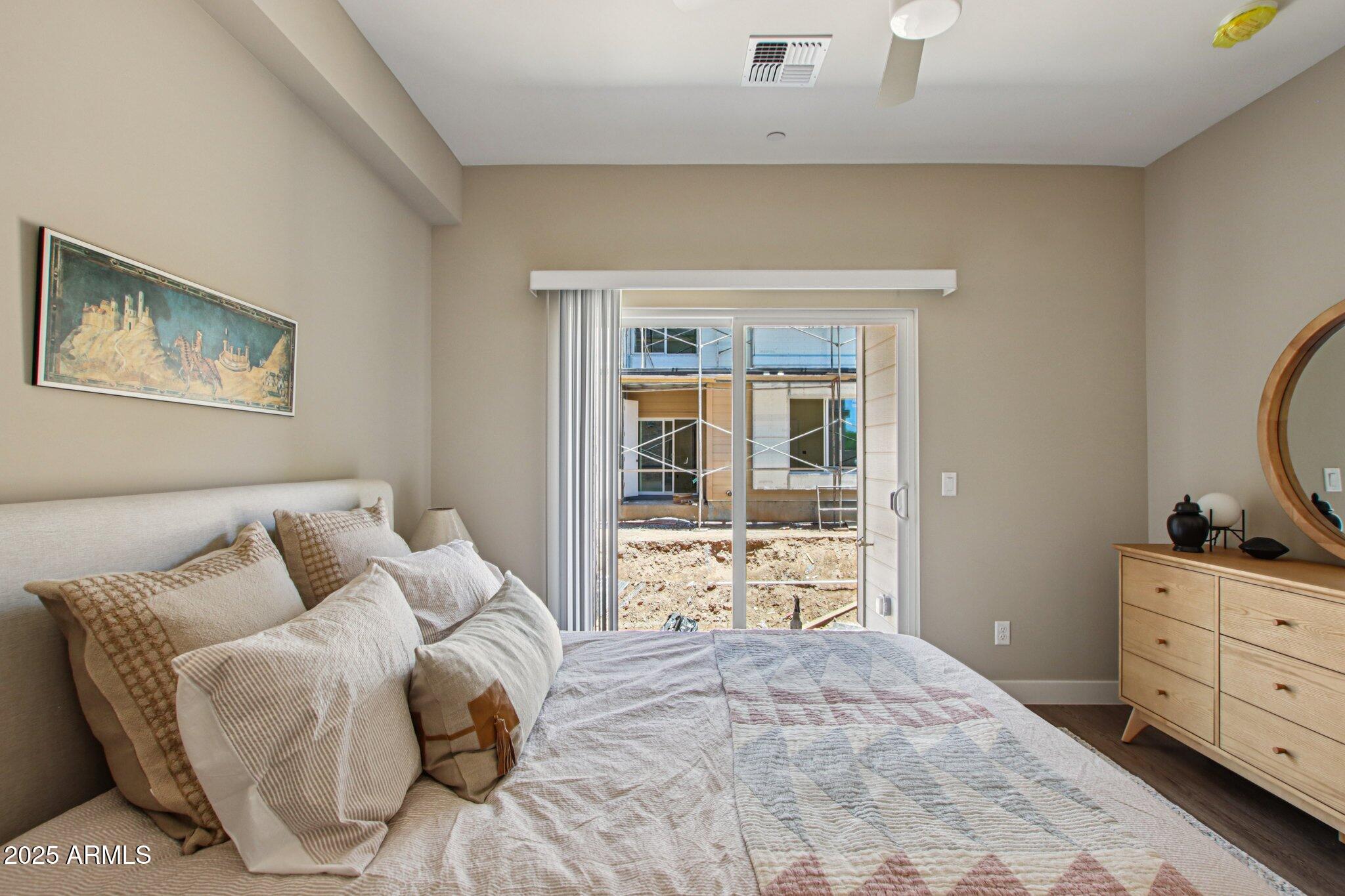1927 South Recker Road, Unit 163 Mesa, AZ 85206 - Photo 20 of 34 a bedroom with a bed and wooden floor