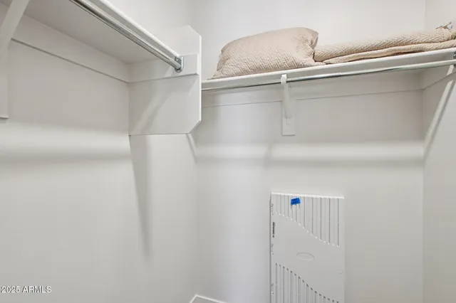 a bathroom with a granite countertop double vanity sink and a mirror