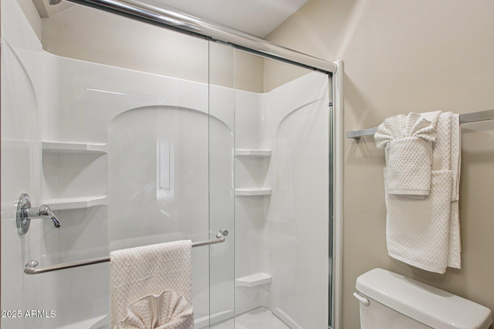 1927 South Recker Road, Unit 163 Mesa, AZ 85206 - Photo 30 of 34 a bathroom with a shower and a toilet