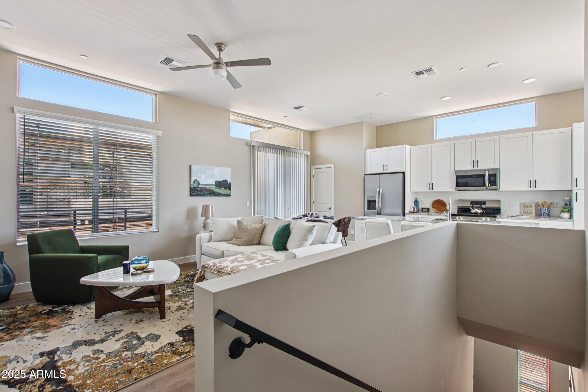 1927 South Recker Road, Unit 163 Mesa, AZ 85206 - Photo 3 of 34 a living room with stainless steel appliances furniture a rug and a view of kitchen