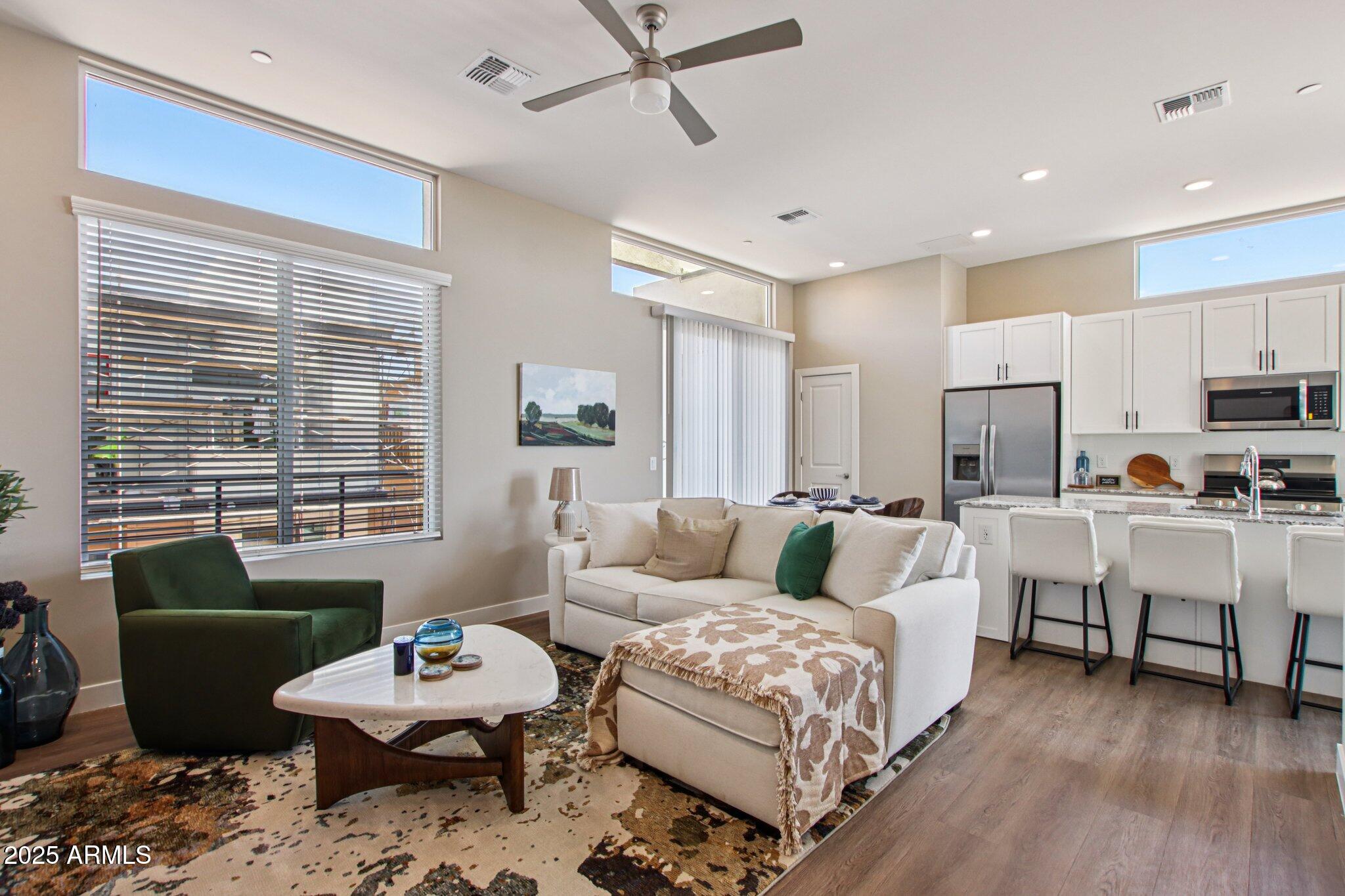 1927 South Recker Road, Unit 163 Mesa, AZ 85206 - Photo 6 of 34 a living room with furniture and a large window