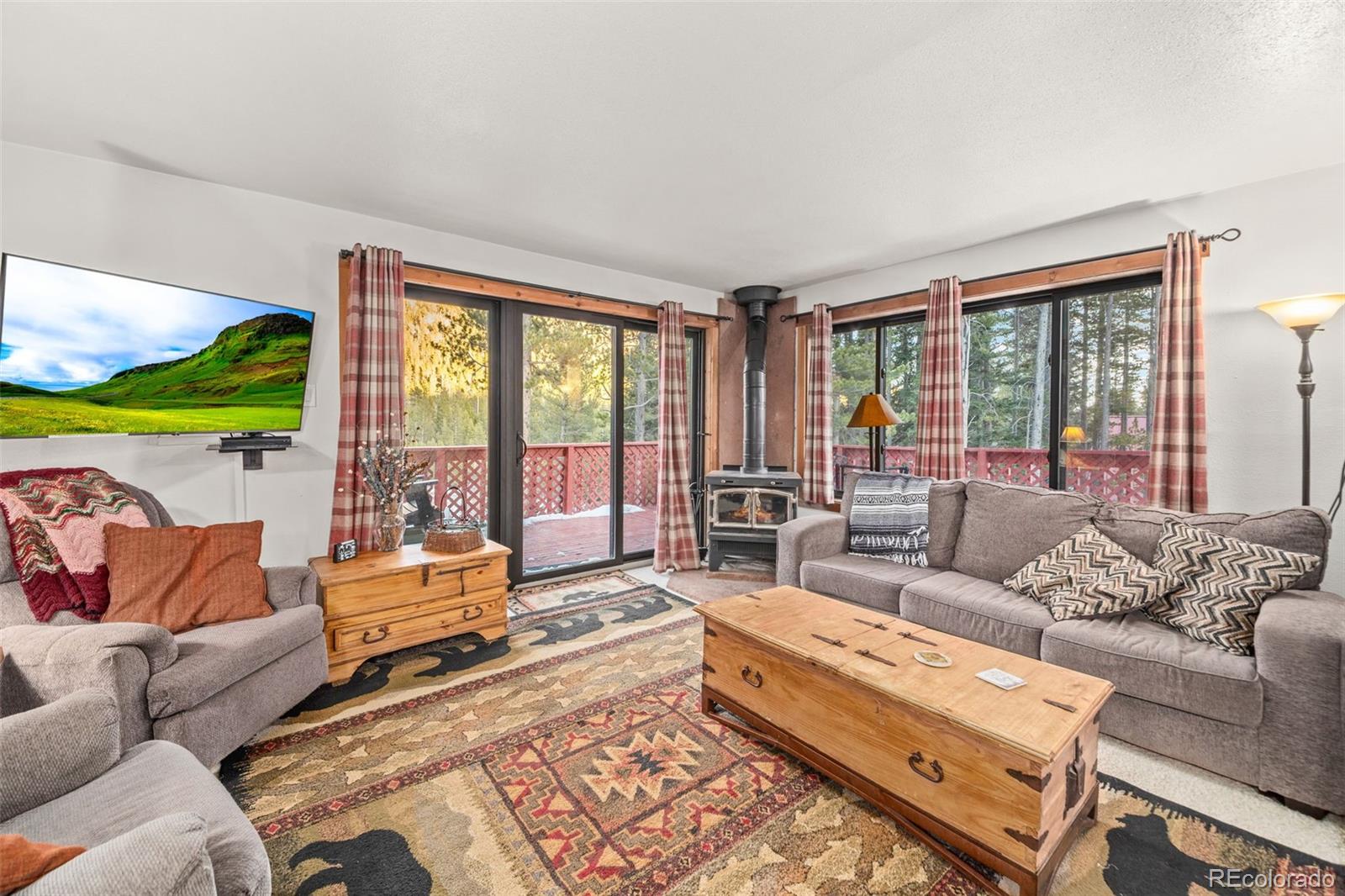 838 Silver Creek Road Idaho Springs, CO 80452 - Photo 2 of 29 a living room with furniture and a large window