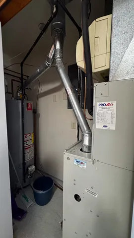 a view of a hallway with wooden floor and a mirror
