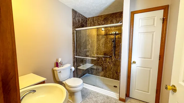 a bathroom with a toilet sink and mirror