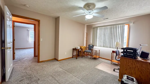 a room with water heater and wooden cabinets