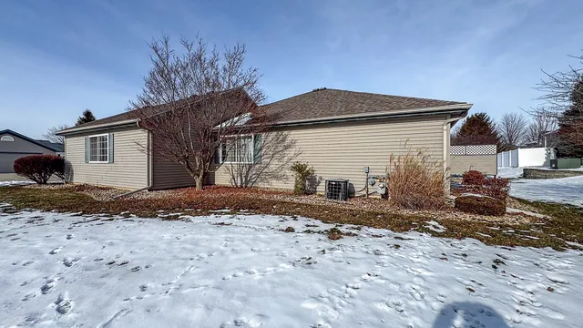a view of a house with a yard covered with snow
