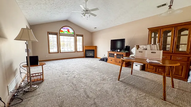 a living room with furniture a chandelier and a flat screen tv