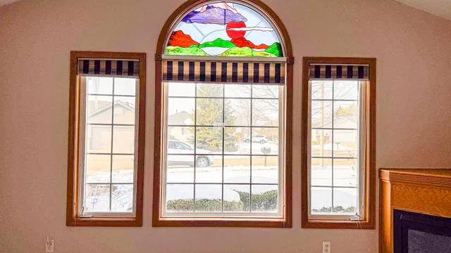 a room with a fireplace and a painting on the wall