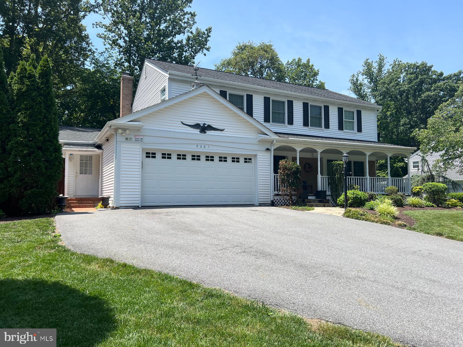9201 Beachway Lane Springfield, VA 22153 - Photo 2 of 12 Charming suburban home with lush greenery.
