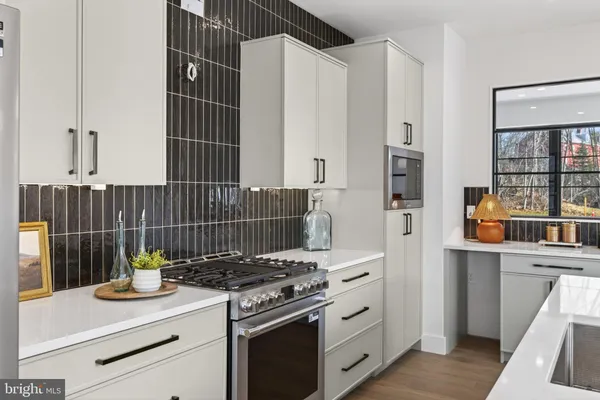 a kitchen with a table chairs and a window