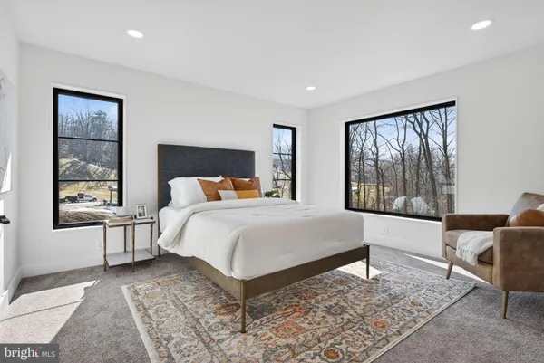 an empty room with windows and ceiling fan