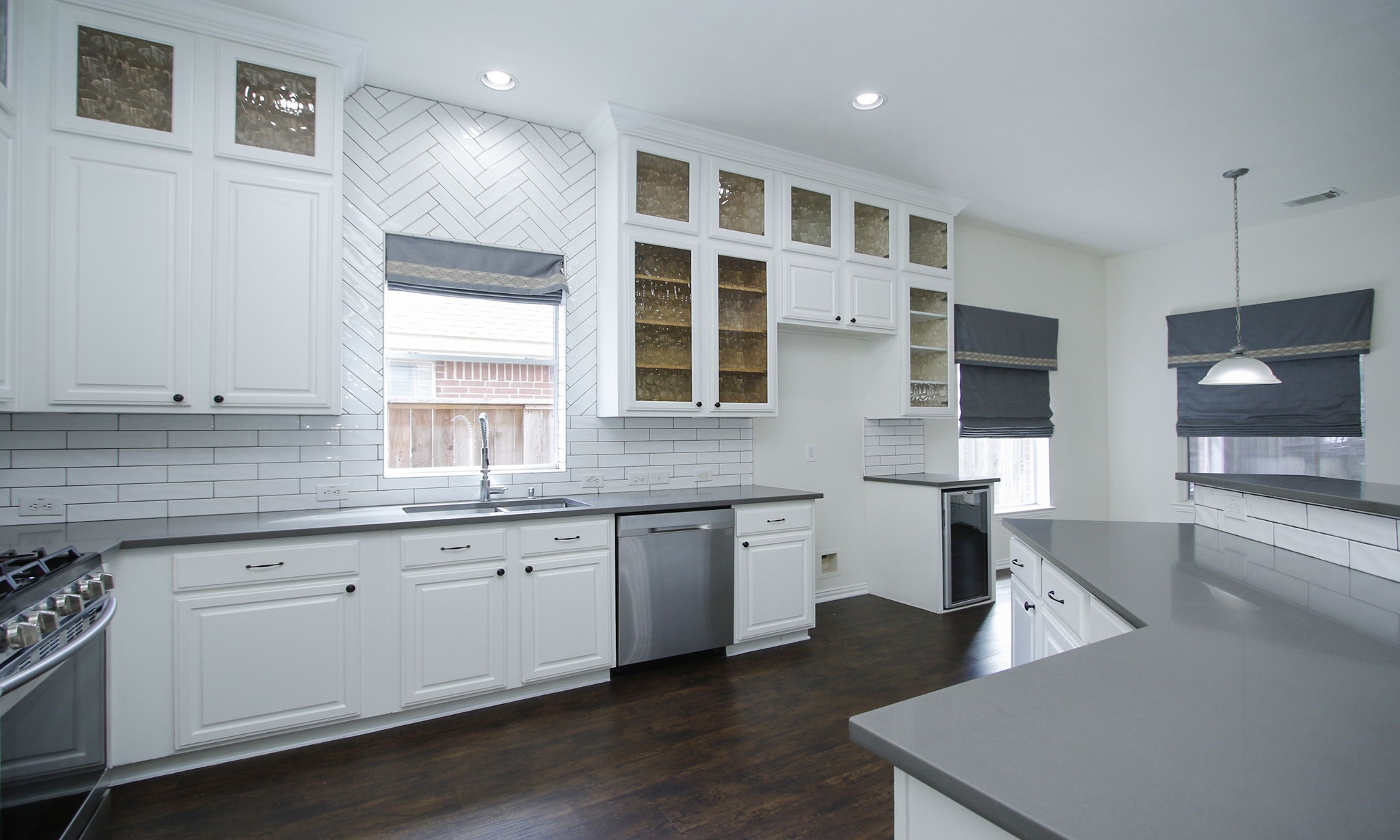 1210 Berwick Manor Court Spring, TX 77379 - Photo 22 of 50 a large kitchen with granite countertop a sink and a stove top oven