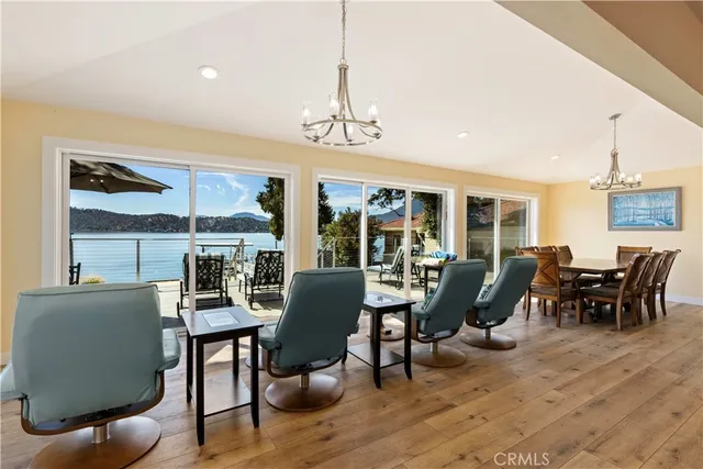 a living room with furniture kitchen view and a chandelier
