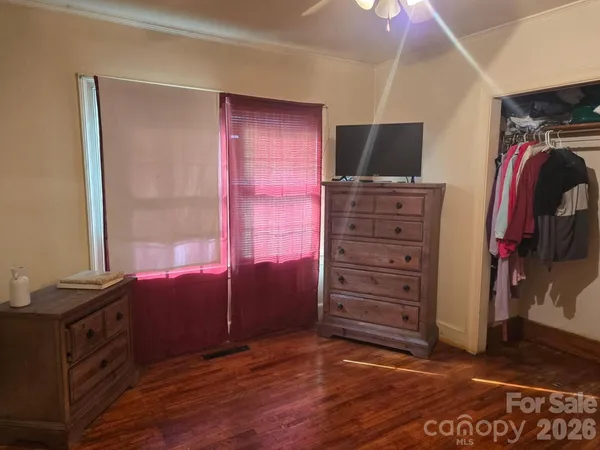 a view of room with window and a flat screen tv
