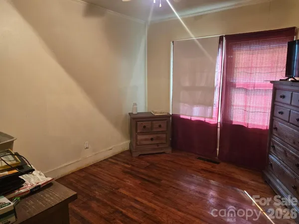 a view of a room with wooden floor