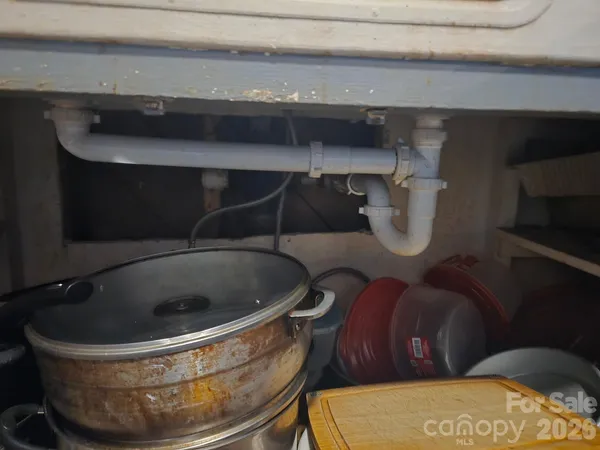 a view of a kitchen with a cabinets and a clock on wall