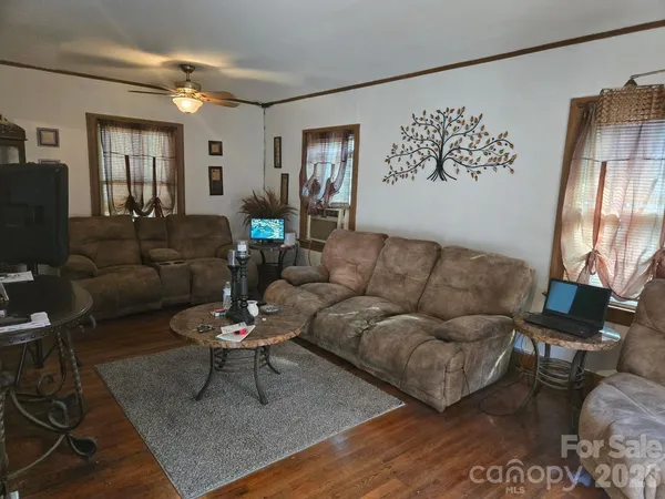 a living room with furniture a rug and a painting on the wall