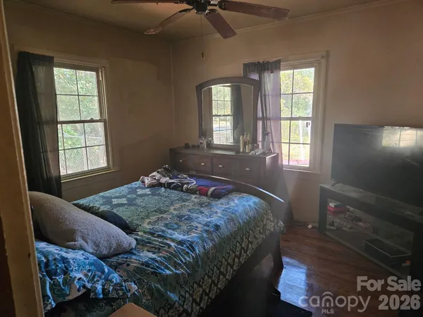 a bedroom with a bed and window
