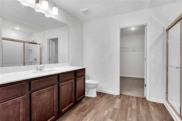 a bathroom with a double vanity sink toilet and shower