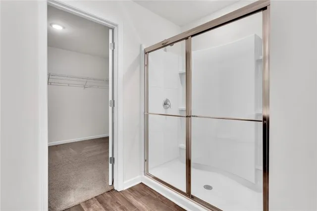 a bathroom with a glass shower door