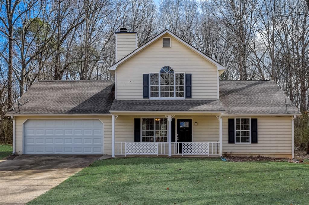 645 Cowan Road Covington, GA 30016 - Photo 1 of 1 a front view of a house with a garden