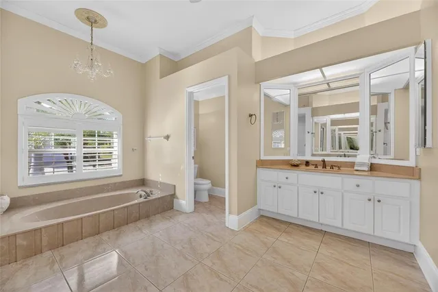 a kitchen with stainless steel appliances kitchen island granite countertop a refrigerator a stove top oven and a sink with cabinets