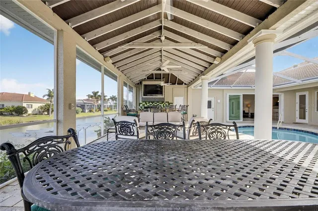 a view of a roof deck with two couches and potted plants with wooden floor