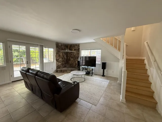 a living room with furniture and flat screen tv
