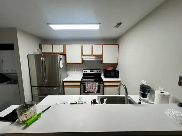 a kitchen with a refrigerator and a stove