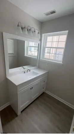 a bathroom with a sink and a window