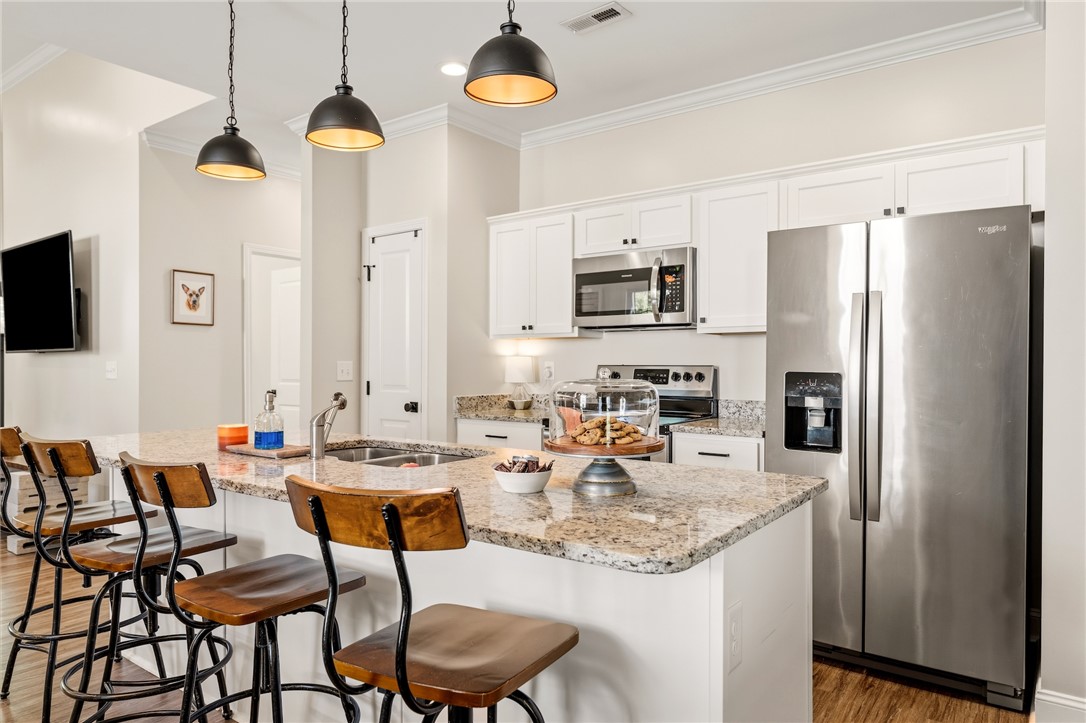 47 A Main Street Pelzer, SC 29669 - Photo 9 of 27 This spacious kitchen offers a large island with seating, perfect for casual dining and entertaining.