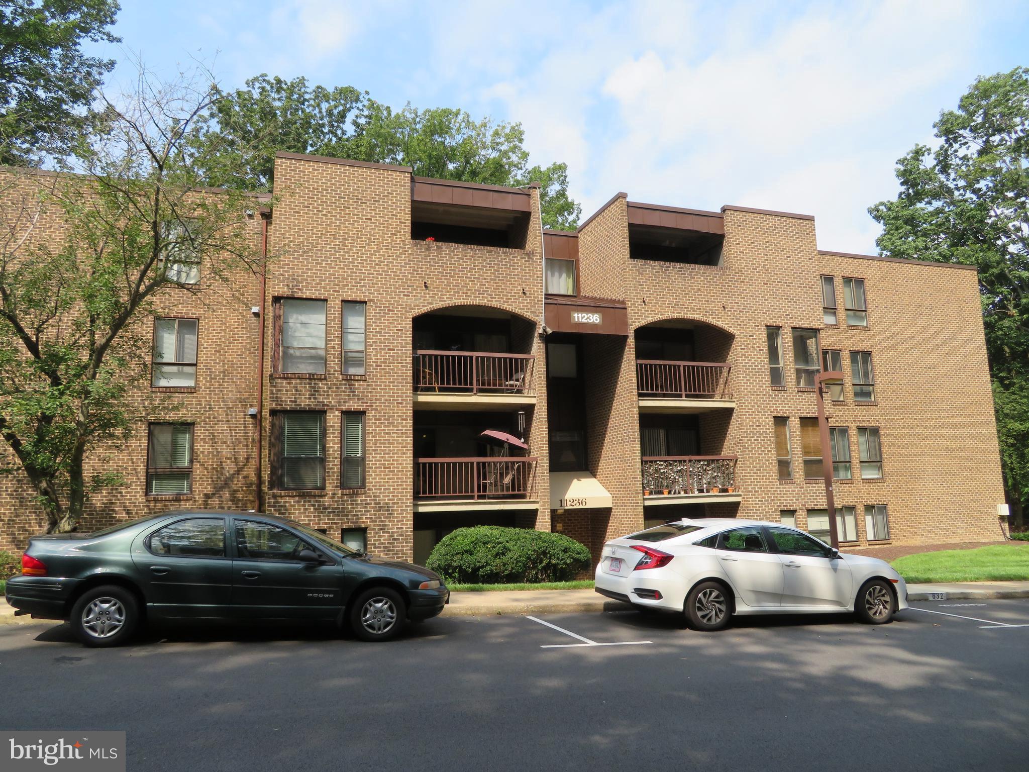11236 Chestnut Grove Square, Unit 261 Reston, VA 20190 - Photo 2 of 30 a car parked in front of a house