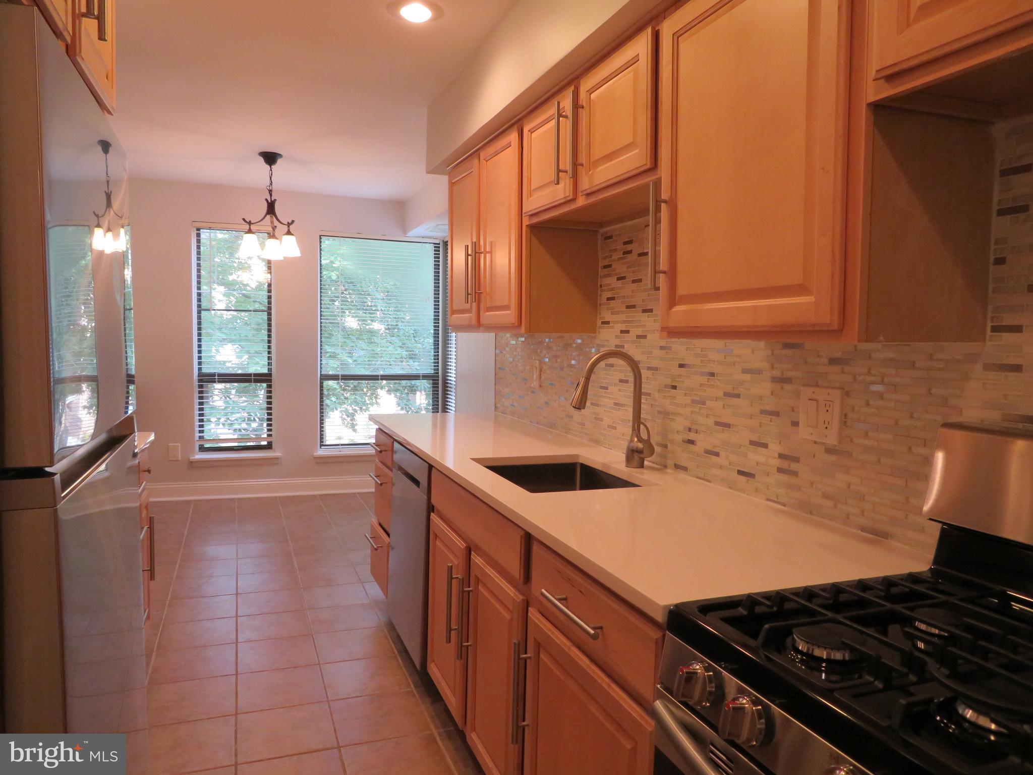 11236 Chestnut Grove Square, Unit 261 Reston, VA 20190 - Photo 11 of 30 a kitchen that has a sink and a stove